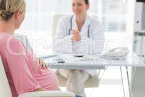 Expectant woman consulting doctor
