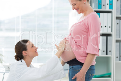 Doctor examining expectant woman