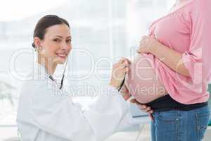 Portrait of doctor examining pregnant woman