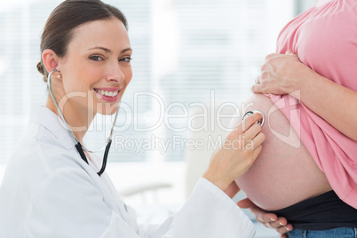 Portrait of doctor checking pregnant woman Portrait of doctor checking pregnant woman