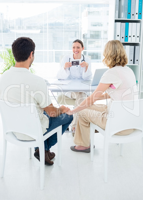Expectant couple consulting gynaecologist
