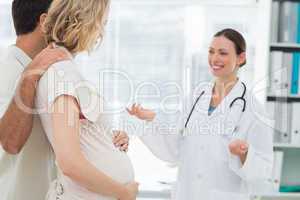 Gynaecologist welcoming expectant couple