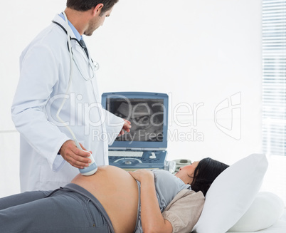 Male doctor performing ultrasound