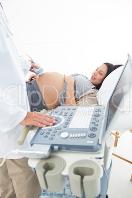 Male doctor examining pregnant woman