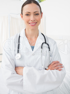 Confident doctor with arms crossed smiling