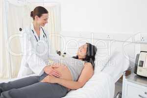 Female doctor attending pregnant woman
