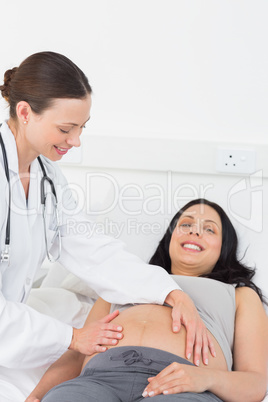 Expectant woman being checked by doctor