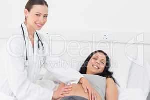Beautiful doctor checking expectant woman