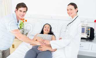Happy doctor and expectant couple