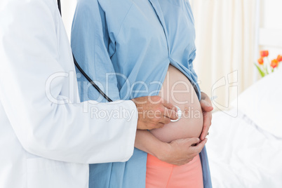 Doctor checking expectant woman