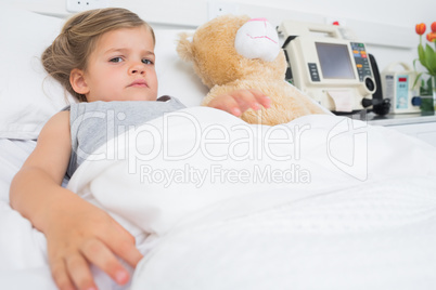 Cute girl lying in hospital bed