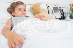 Cute girl lying in hospital bed