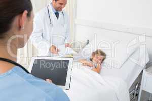 Doctors attending sick girl