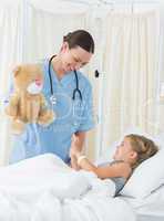Playful doctor entertaining sick girl