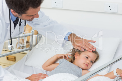 Doctor checking temperature of sick girl