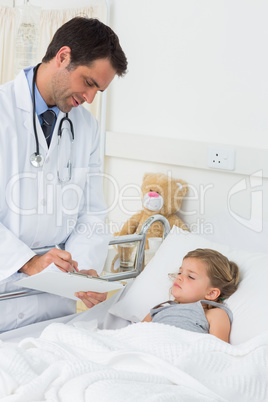 Doctor writing on clipboard while attending ill girl