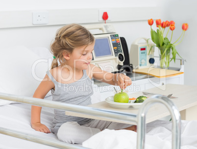 Girl eating healthy food in hospital