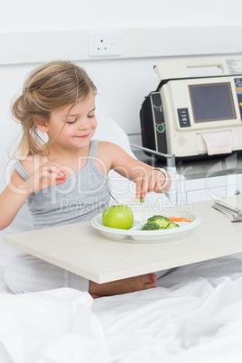 Sick girl having breakfast in hospital