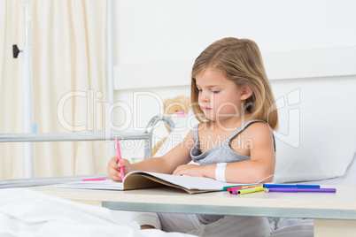 Girl coloring book in hospital