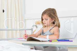 Girl coloring book in hospital