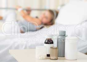 Medicines on table with girl in hospital