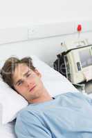 Sick man lying in hospital bed