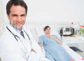 Confident male doctor in hospital ward