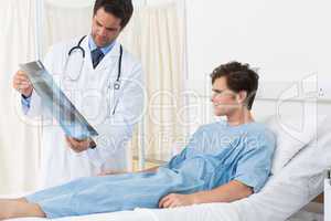 Doctor showing Xray report to patient