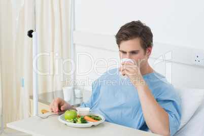 Male patient having meal in hospital