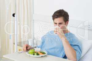 Male patient having meal in hospital