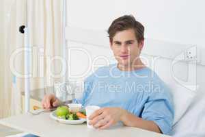Patient having meal on hospital bed