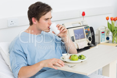 Patient drinking water while having meal