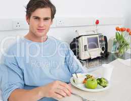 Handsome man having meal in hospital
