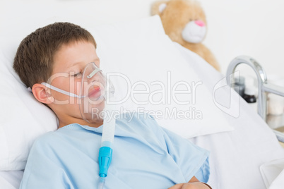 Boy with oxygen mask in bed