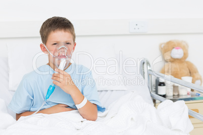 Boy wearing oxygen mask in hospital