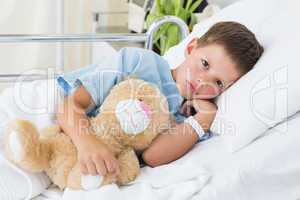 Little boy with teddy bear in hospital