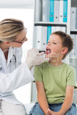 Doctor looking at the mouth of boy