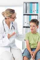 Doctor talking with boy in clinic