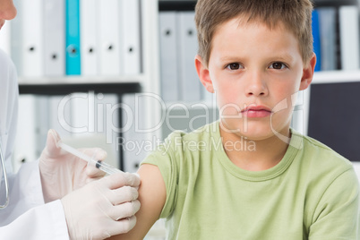 Boy receiving an injection by pediatrician