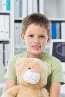 Boy with teddy bear in clinic