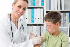 Little boy receiving injection by pediatrician