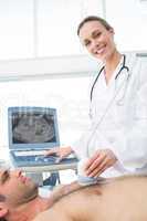 Doctor using ultrasound scan on male patient