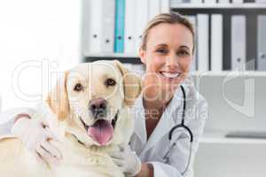 Confident female veterinarian with dog