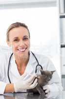 Female vet injecting a kitten