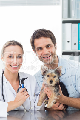 Vet and pet owner with puppy