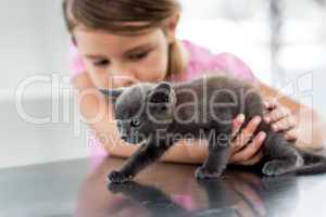 Girl playing with kitten