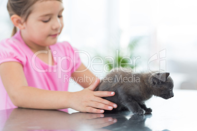 Girl playing with kitten