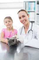 Veterinary and girl with kitten in clinic