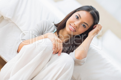 Young girl sitting on the floor smiling at camera