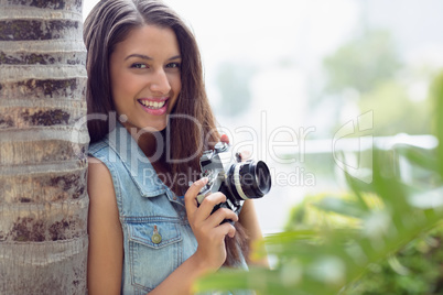 Stylish young photographer smiling at camera